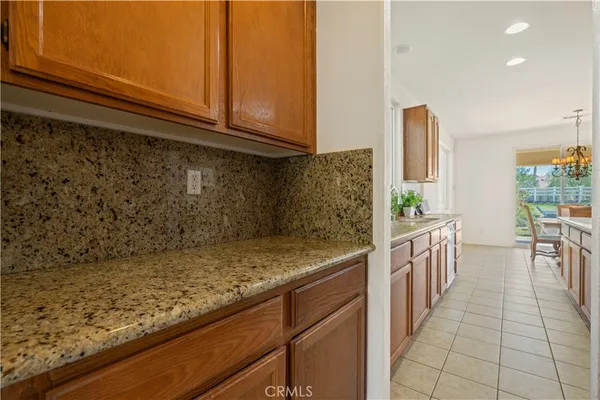 a kitchen with granite countertop a sink and a stove