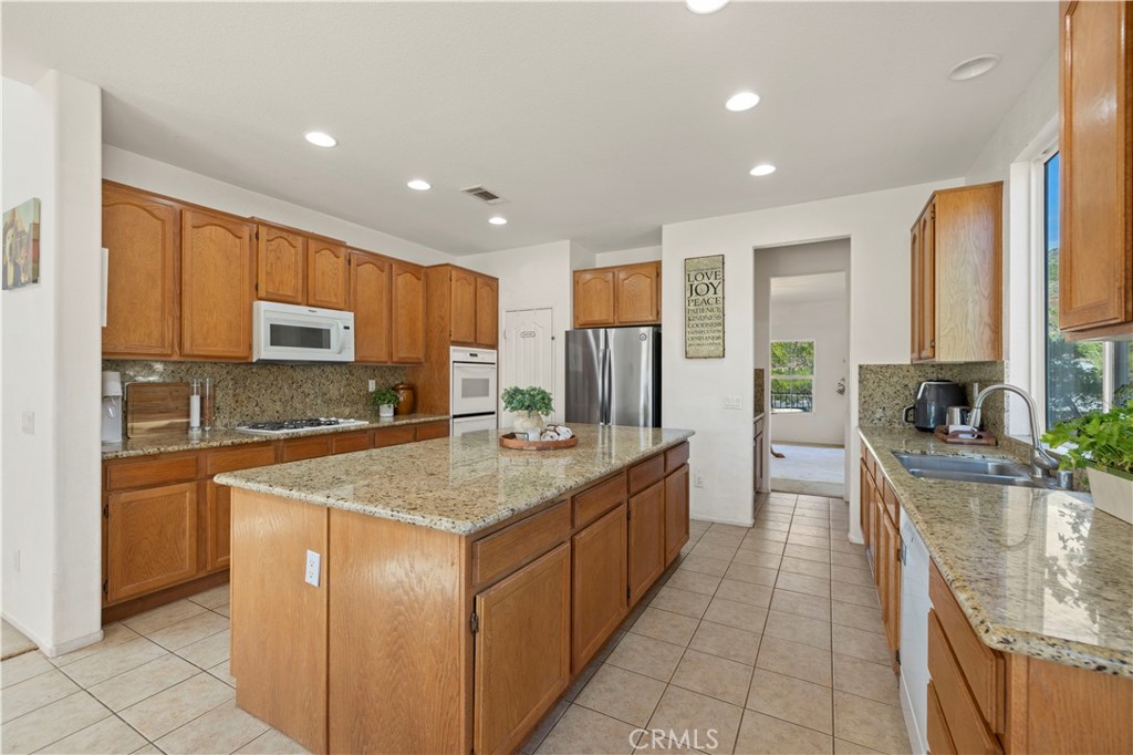 34250 McEnnery Canyon Road Acton, CA 93510 - Photo 9 of 63 a kitchen with stainless steel appliances granite countertop a refrigerator a sink dishwasher a oven and a refrigerator