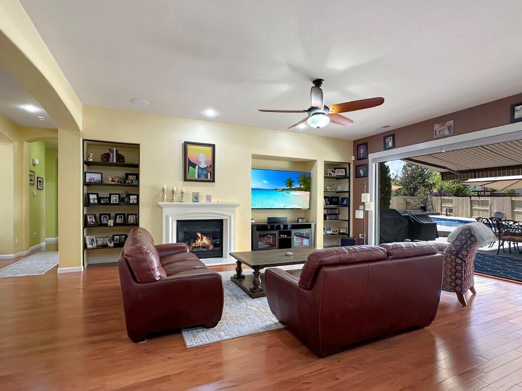 10555 Hampton Creek Drive Reno, NV 89521 - Photo 12 of 50 a living room with furniture a fireplace and a large window