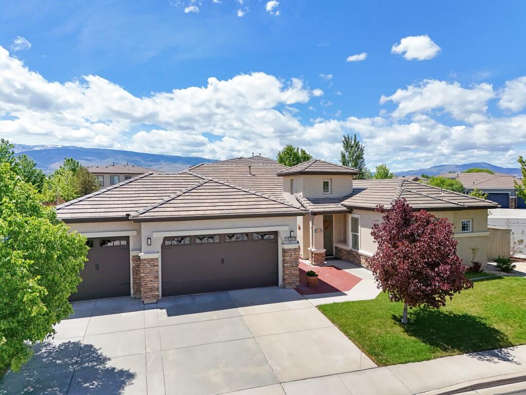 10555 Hampton Creek Drive Reno, NV 89521 - Photo 2 of 50 a front view of a house with garden