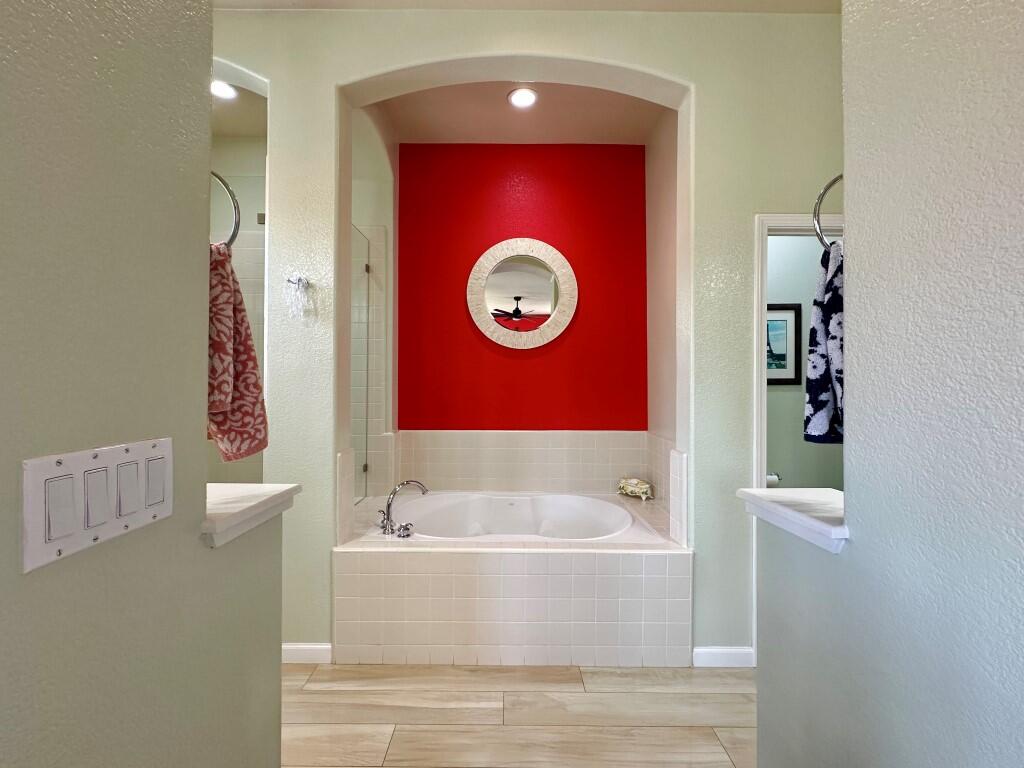 10555 Hampton Creek Drive Reno, NV 89521 - Photo 22 of 50 a bathroom with a bathtub and a shower