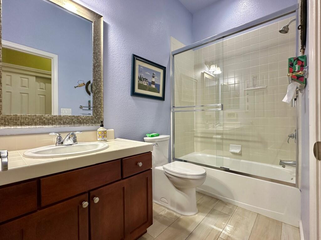 10555 Hampton Creek Drive Reno, NV 89521 - Photo 27 of 50 a bathroom with a double vanity sink toilet and shower