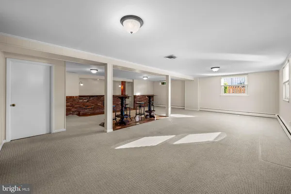 en empty room with furniture and a large window