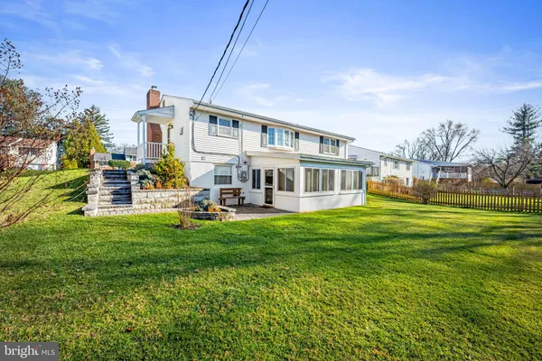 a view of a house with a yard porch and sitting area