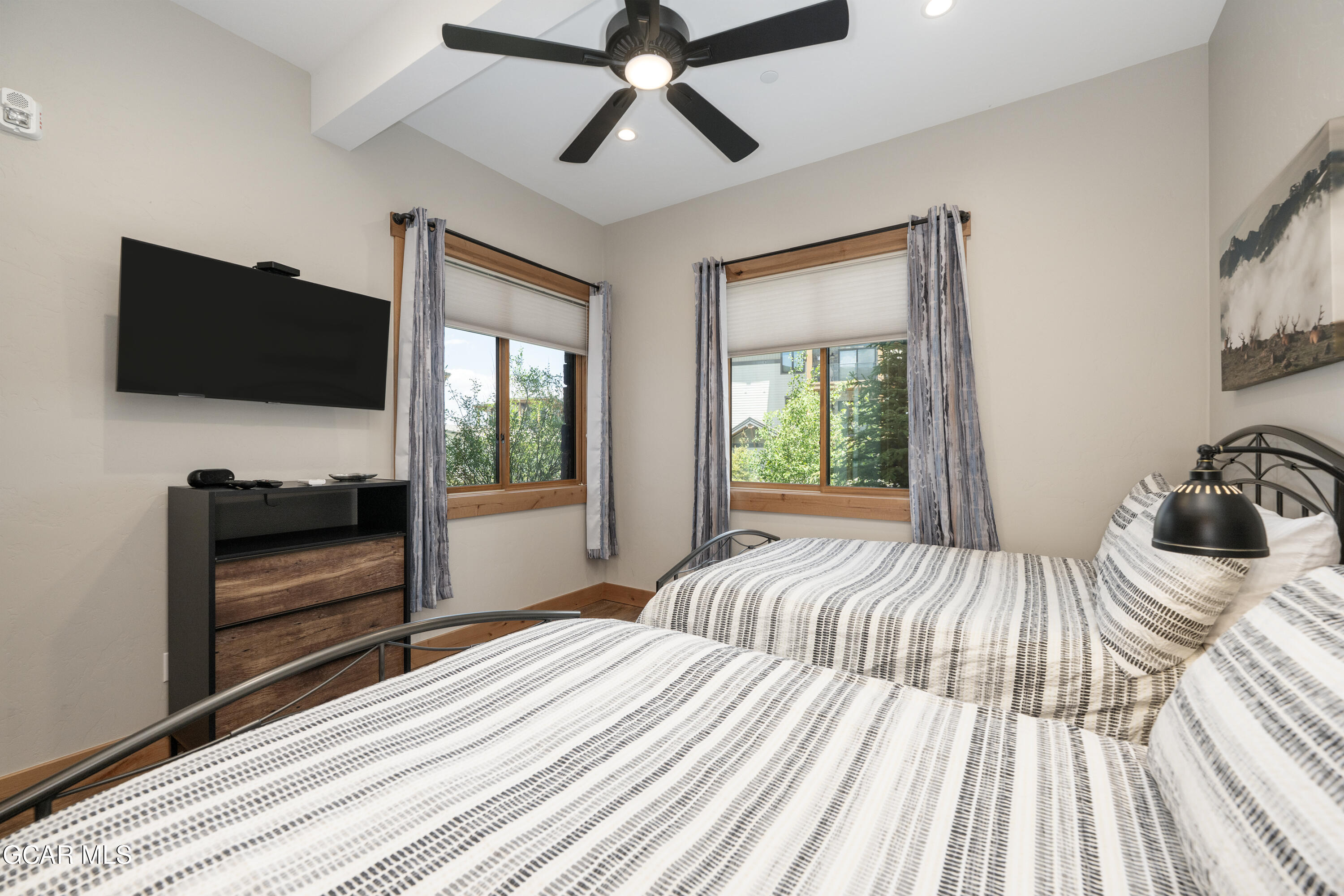 40 Springview Lane Fraser, CO 80442 - Photo 25 of 36 a bedroom with a bed and a flat tv screen on dresser