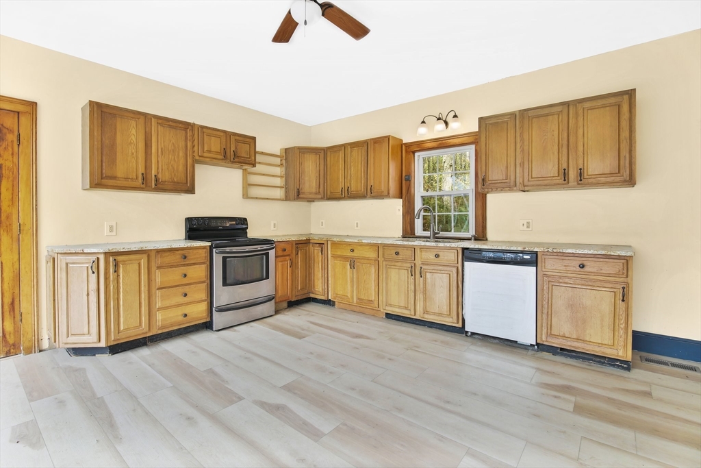 40 Holcomb Road Chester, MA 01011 - Photo 6 of 34 a kitchen with stove cabinets and wooden floor