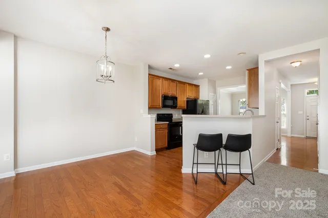 a view of kitchen with kitchen island microwave and cabinets