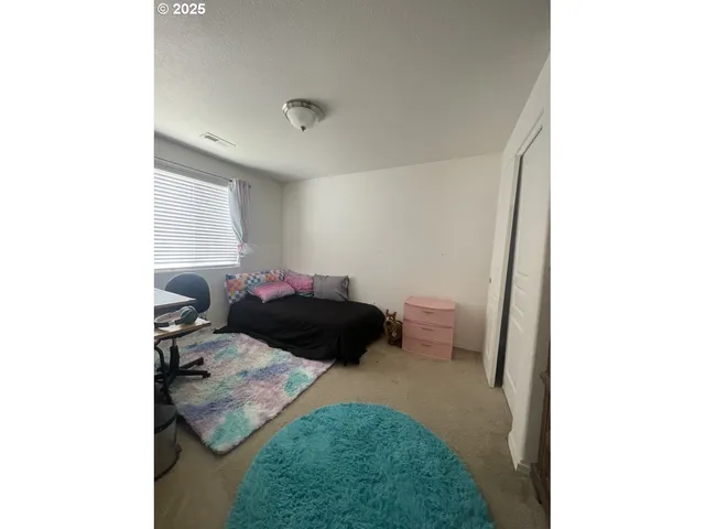 a bedroom with a bed and a cabinets
