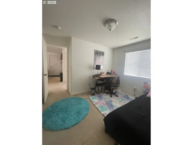 a living room with furniture and a mirror