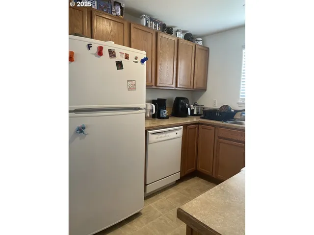 a white refrigerator freezer sitting inside of a kitchen