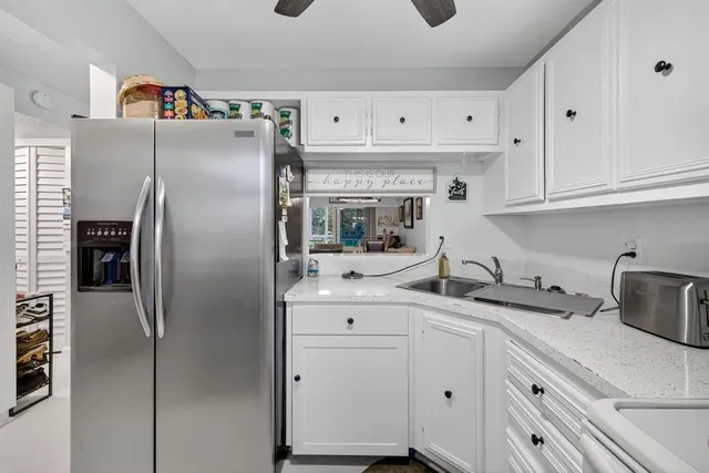 a kitchen with stainless steel appliances a refrigerator sink and cabinets