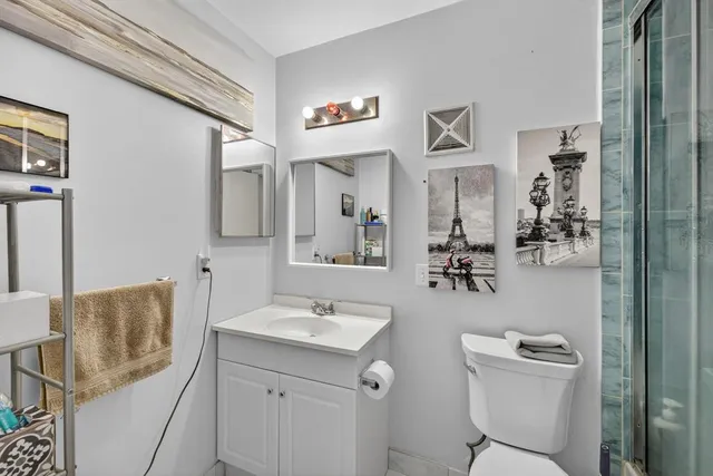 a bathroom with a sink a toilet and mirror