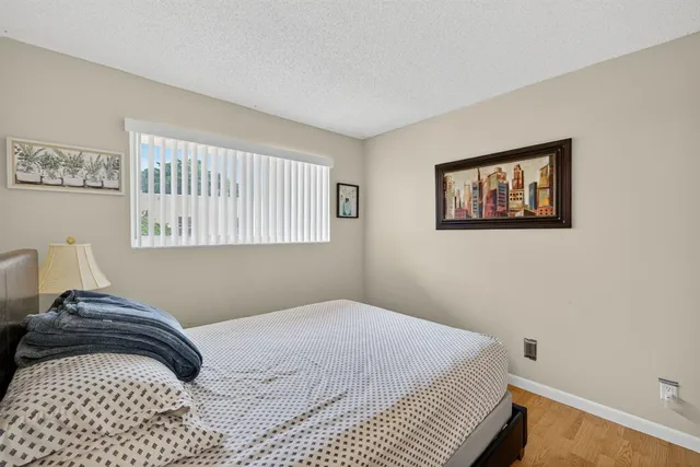 a bedroom with a bed and a painting on the wall