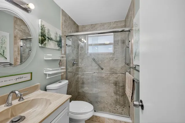 a white toilet sitting next to a bathroom sink