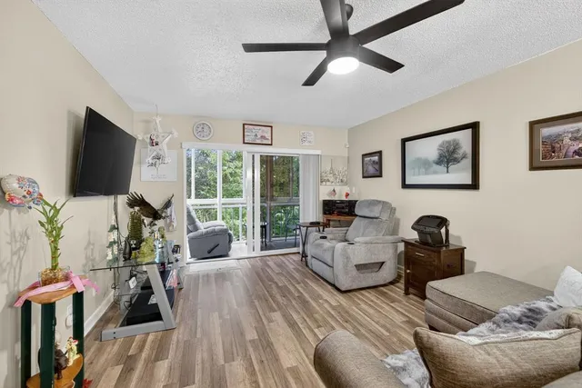 a living room with furniture tv and a flat screen tv