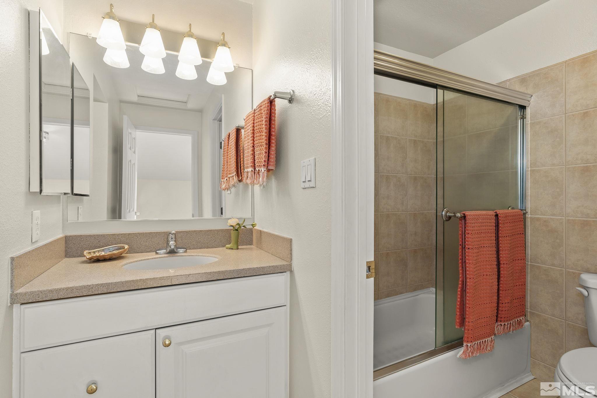 1220 Laredo Court Reno, NV 89503 - Photo 17 of 29 a bathroom with a sink and a mirror