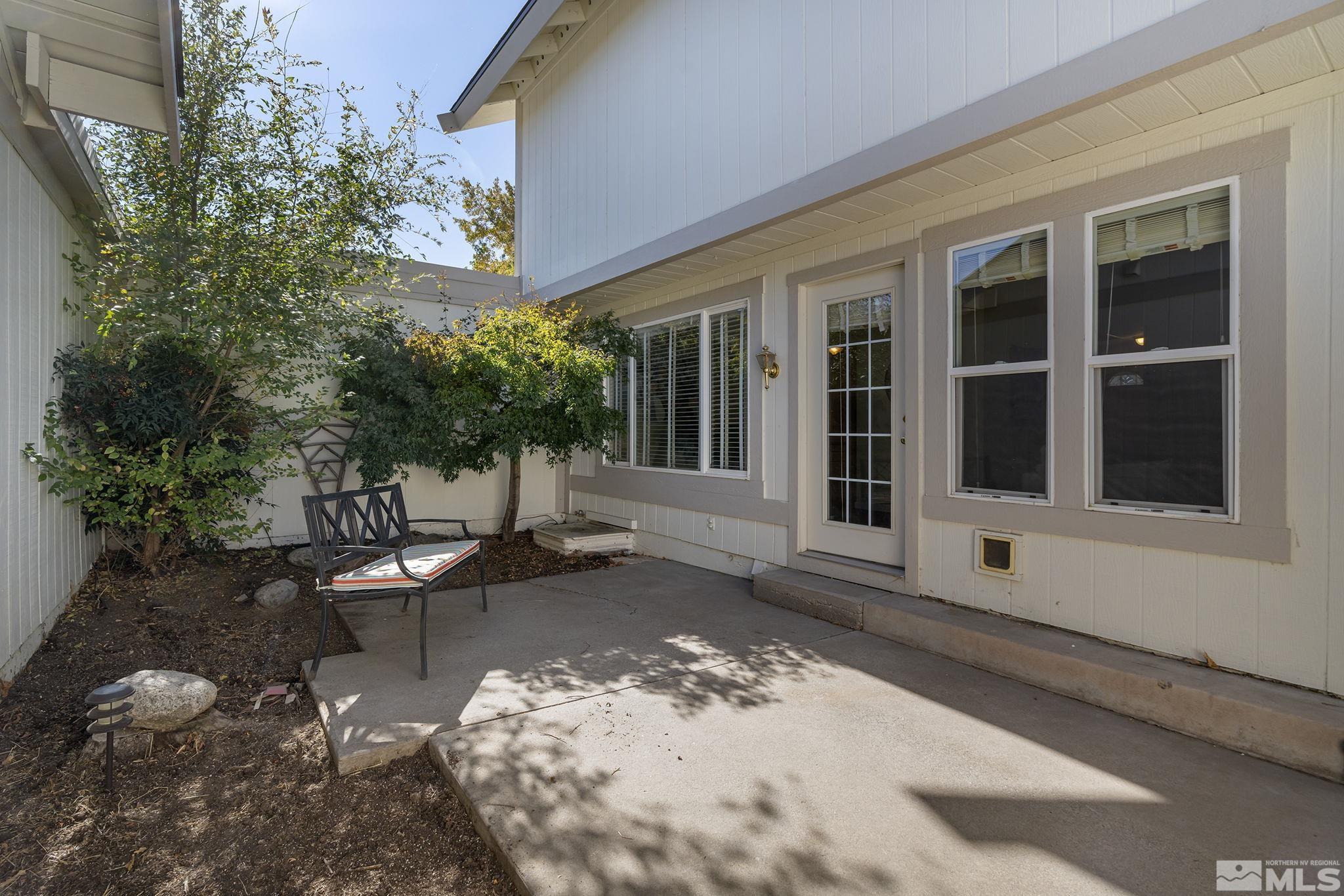 1220 Laredo Court Reno, NV 89503 - Photo 23 of 29 a view of a house with backyard sitting area and garden