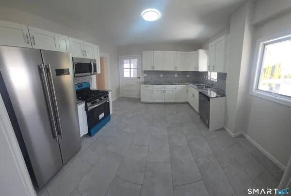 a kitchen with a refrigerator and a sink