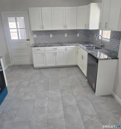 a kitchen with cabinets and appliances