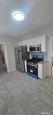 a kitchen with stainless steel appliances a stove a sink and a refrigerator
