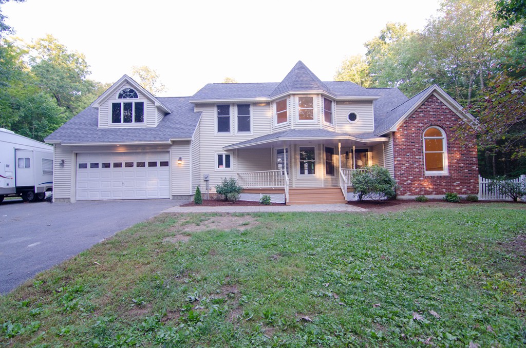 a front view of a house with a yard and garage