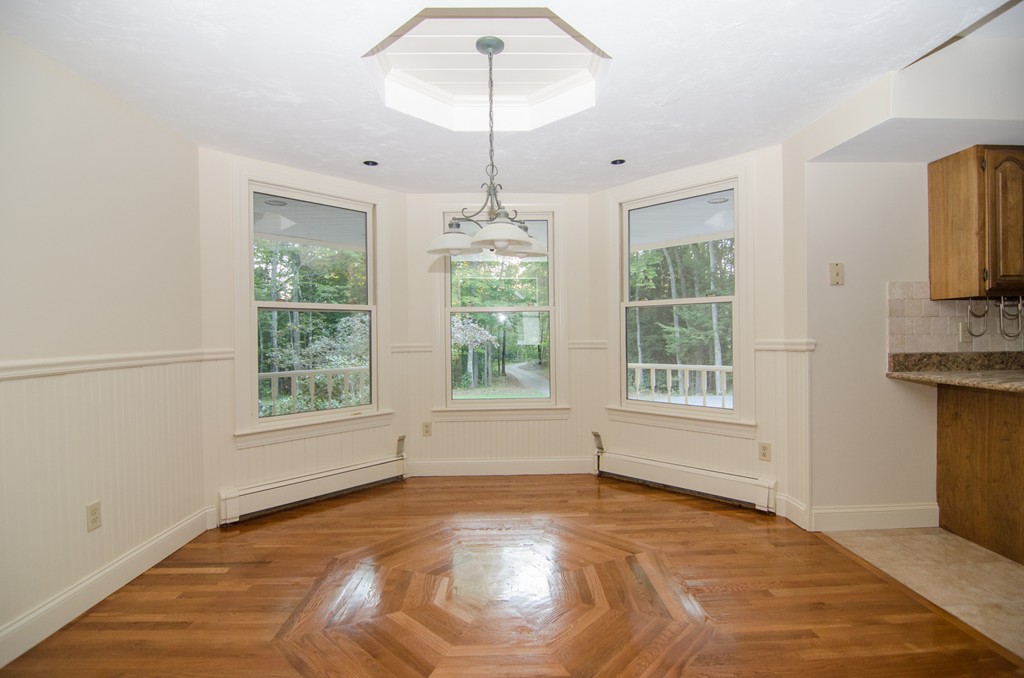 1820 New Sherborn Road Athol, MA 01331 - Photo 6 of 27 a view of an empty room with a window and a kitchen