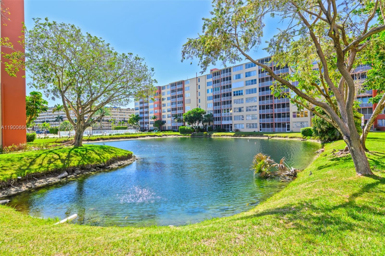 1770 Northeast 191st Street, Unit 5081 Miami, FL 33179 - Photo 12 of 35 a view of a lake with a building in the background