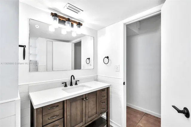 a bathroom with a sink a mirror and a vanity