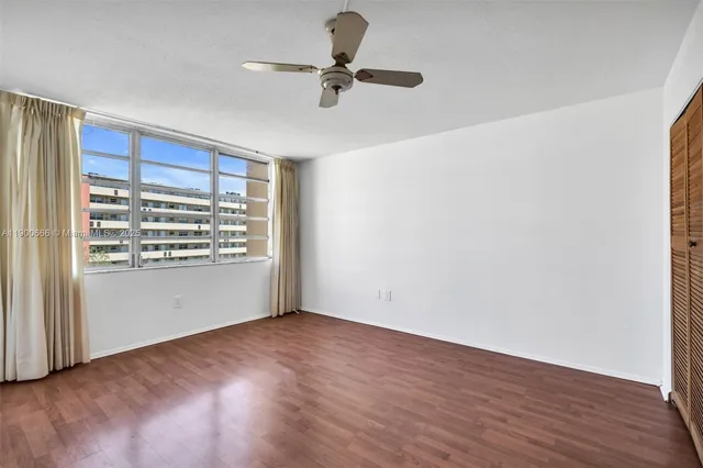 a view of room with a ceiling fan and window