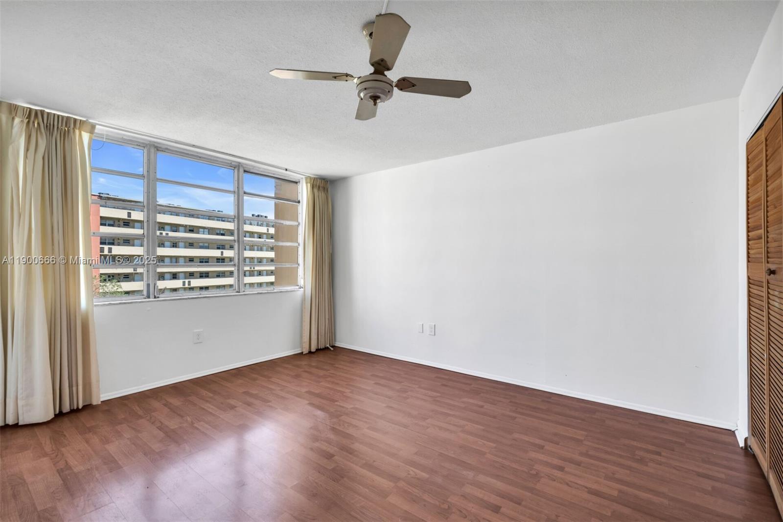 1770 Northeast 191st Street, Unit 5081 Miami, FL 33179 - Photo 25 of 35 a view of room with a ceiling fan and window