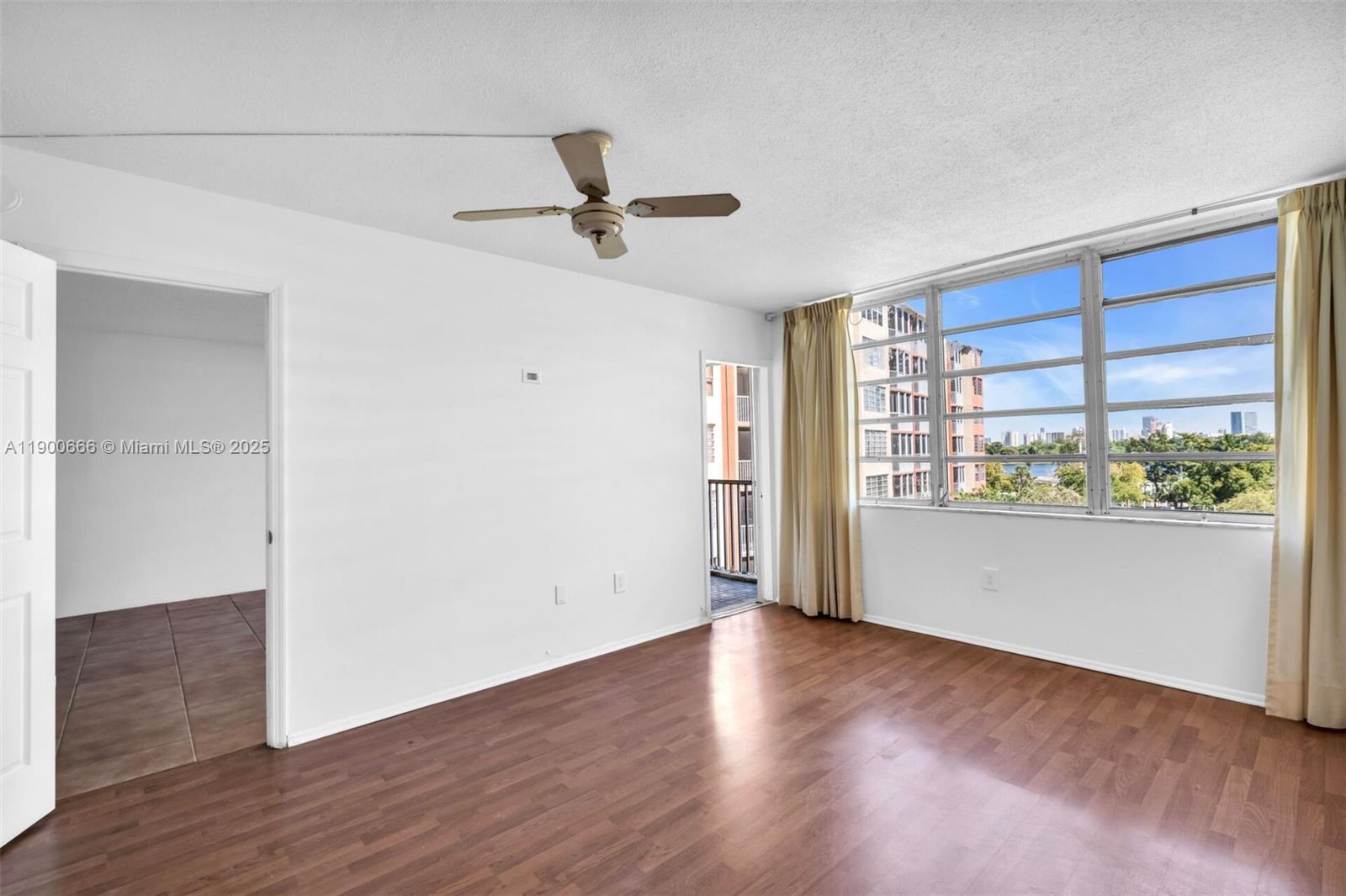1770 Northeast 191st Street, Unit 5081 Miami, FL 33179 - Photo 26 of 35 a view of empty room with wooden floor and fan
