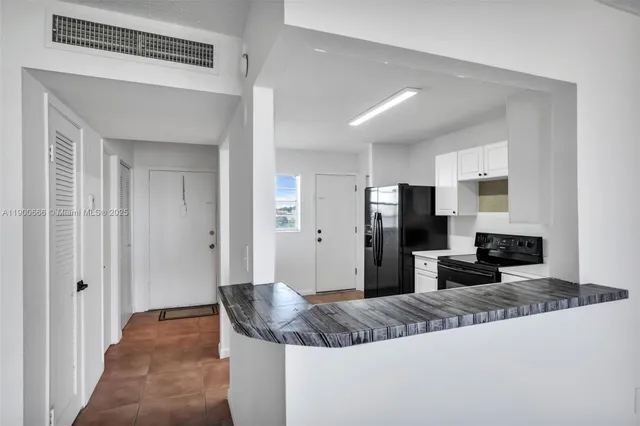 a large bedroom with bed and mirror