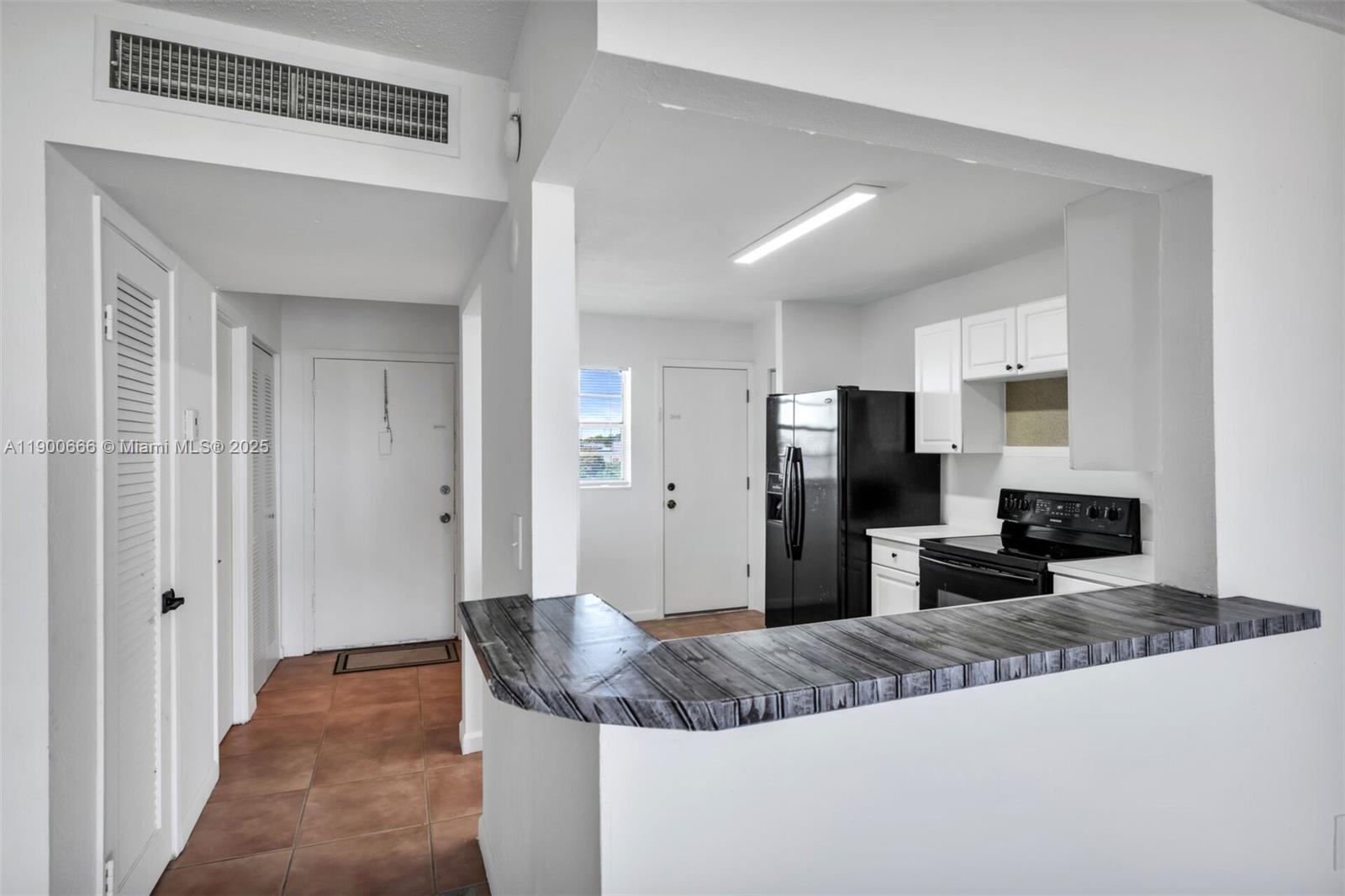 1770 Northeast 191st Street, Unit 5081 Miami, FL 33179 - Photo 30 of 35 a large bedroom with bed and mirror