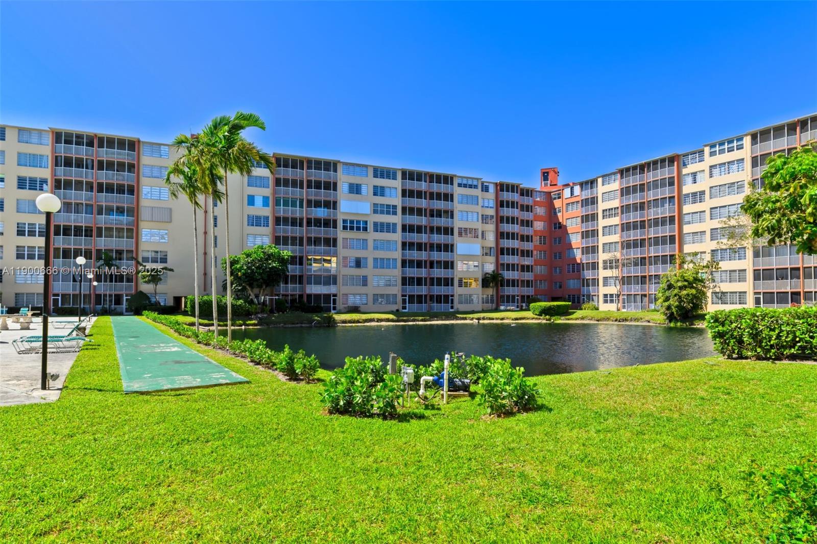 1770 Northeast 191st Street, Unit 5081 Miami, FL 33179 - Photo 9 of 35 a front view of a building with garden