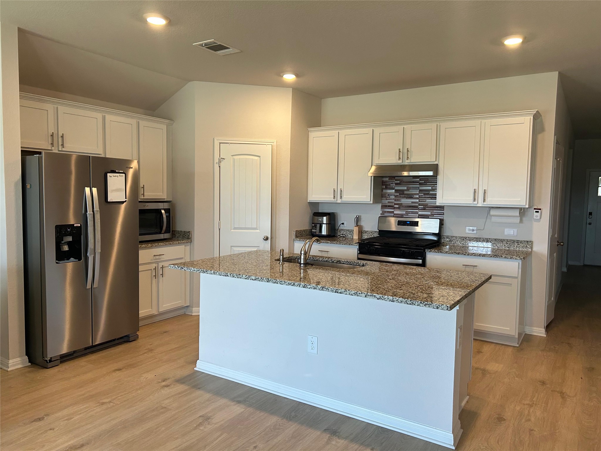 2412 Lightning View Leander, TX 78641 - Photo 5 of 24 Granite counters and stainless steel appliances adorn this functional, well-appointed kitchen.