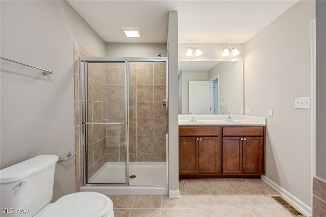 134 Inlet Street Morgantown, WV 26508 - Photo 25 of 44 Bathroom with toilet, walk in shower, vanity, and tile patterned flooring