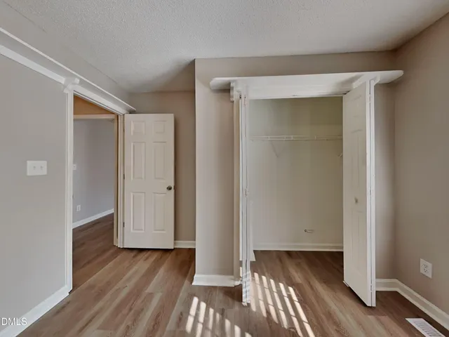 a view of hallway with wooden floor