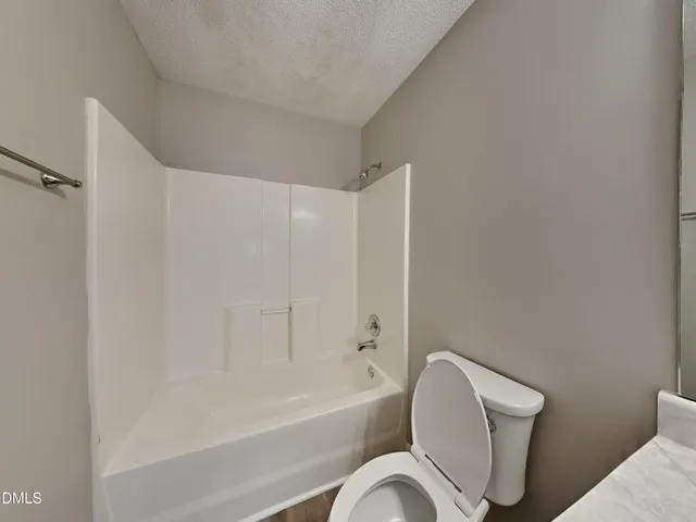 a bathroom with a toilet bathtub and shower