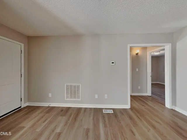 a view of an empty room and wooden floor