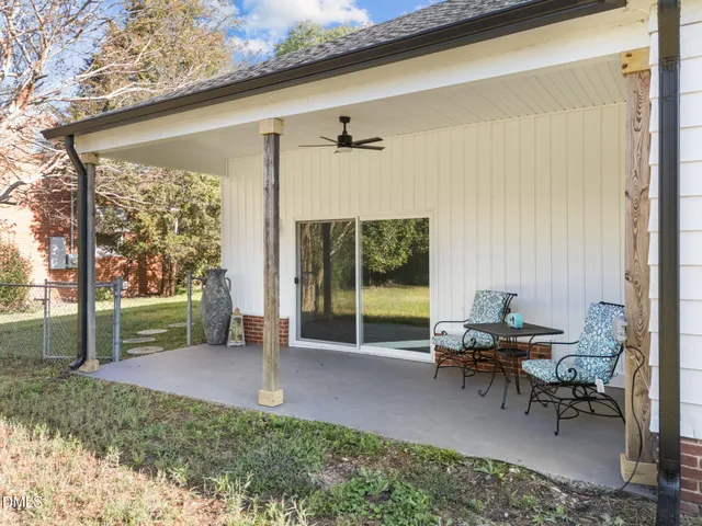 a view of a porch with chairs and backyard