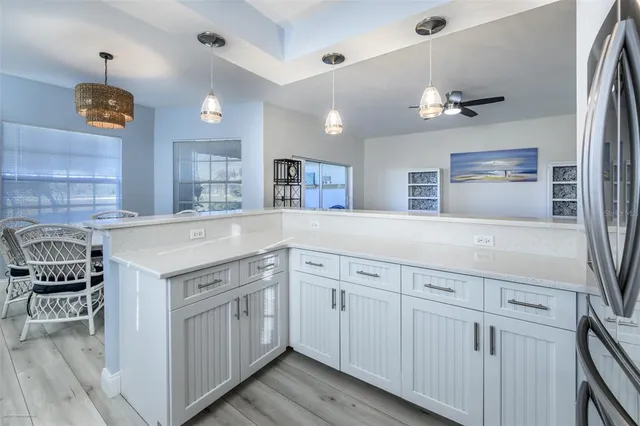 a kitchen with a sink dishwasher a stove and a refrigerator with wooden floor