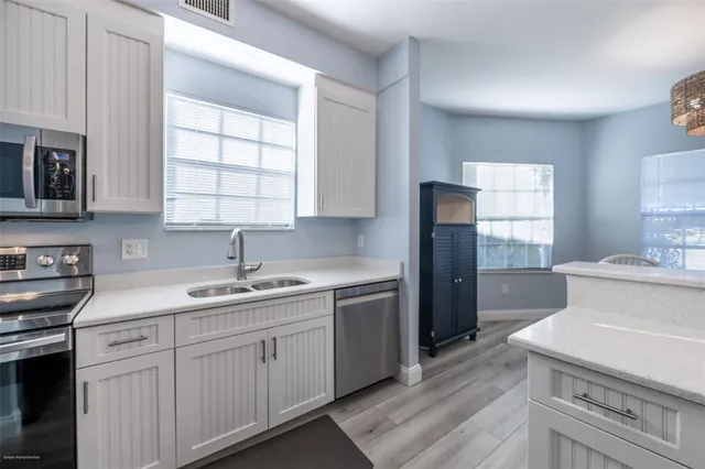 a kitchen with a sink stove and refrigerator