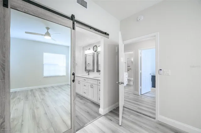 a view of a hallway with wooden floor