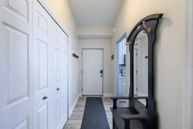 a view of a hallway with wooden floor