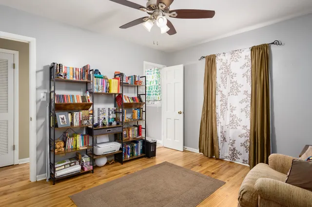 a bedroom with furniture and a book shelf