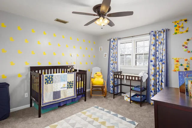 a bedroom with furniture and a window