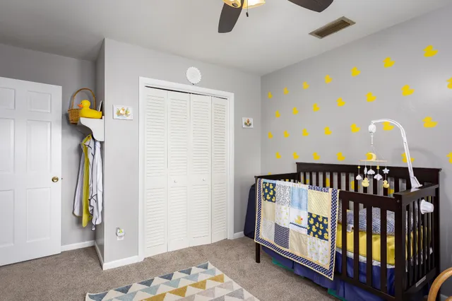 a bedroom with furniture and a rug