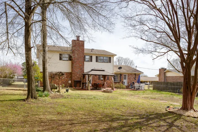 a view of a patio with table and chairs next to a yard