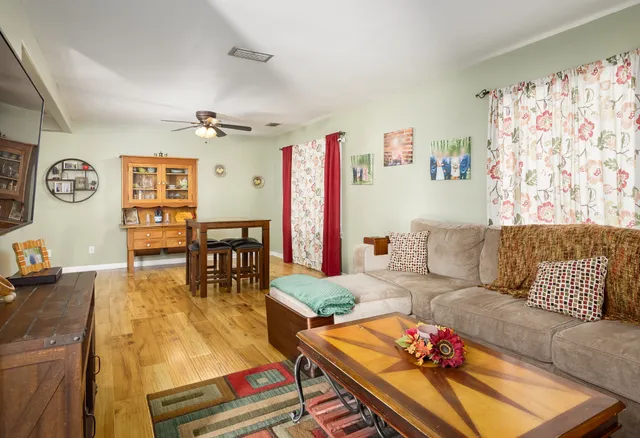 a living room with furniture and wooden floor