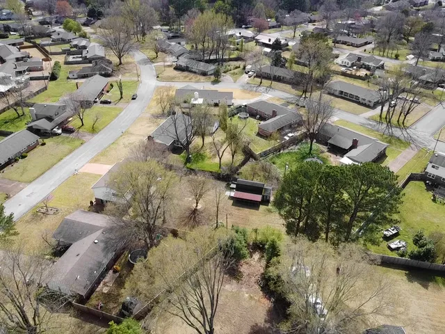 a front view of a house with a yard covered with snow